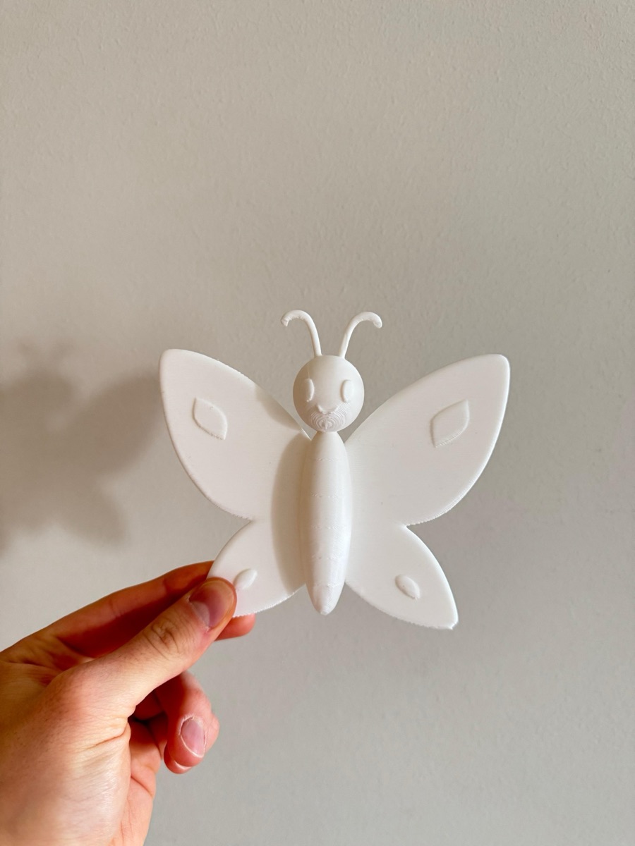 White butterfly figure in a hand
